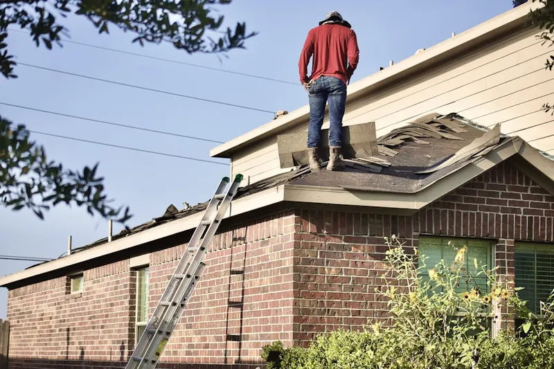 Professional roofer working on a residential roof in Venetian Village